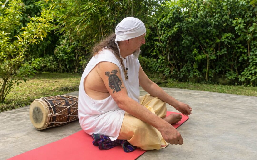 Kirantana Khalsa seated outdoors beside a drum during a Kundalini Yoga immersion in the Philippines in 2016
